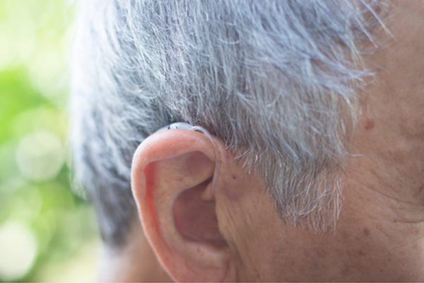 Man wearing a nearly invisible hearing aid 