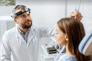 Audiologist Services An Audiologist Is Performing a Hearing Evaluation for a Patient at a Hearing Clinic in Estero, FL
