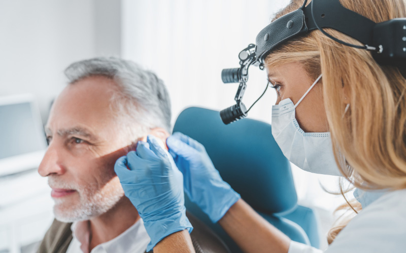 A Doctor inspecting a patient's ear