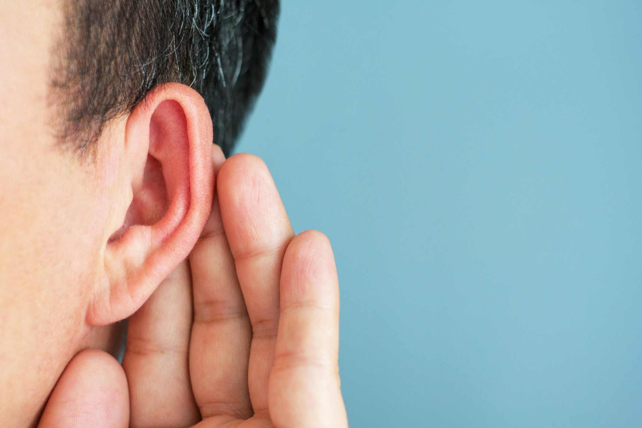 Signs of Hearing Loss Person cupping their ear, showing need for hearing evaluation and hearing aid solutions, Estero, FL